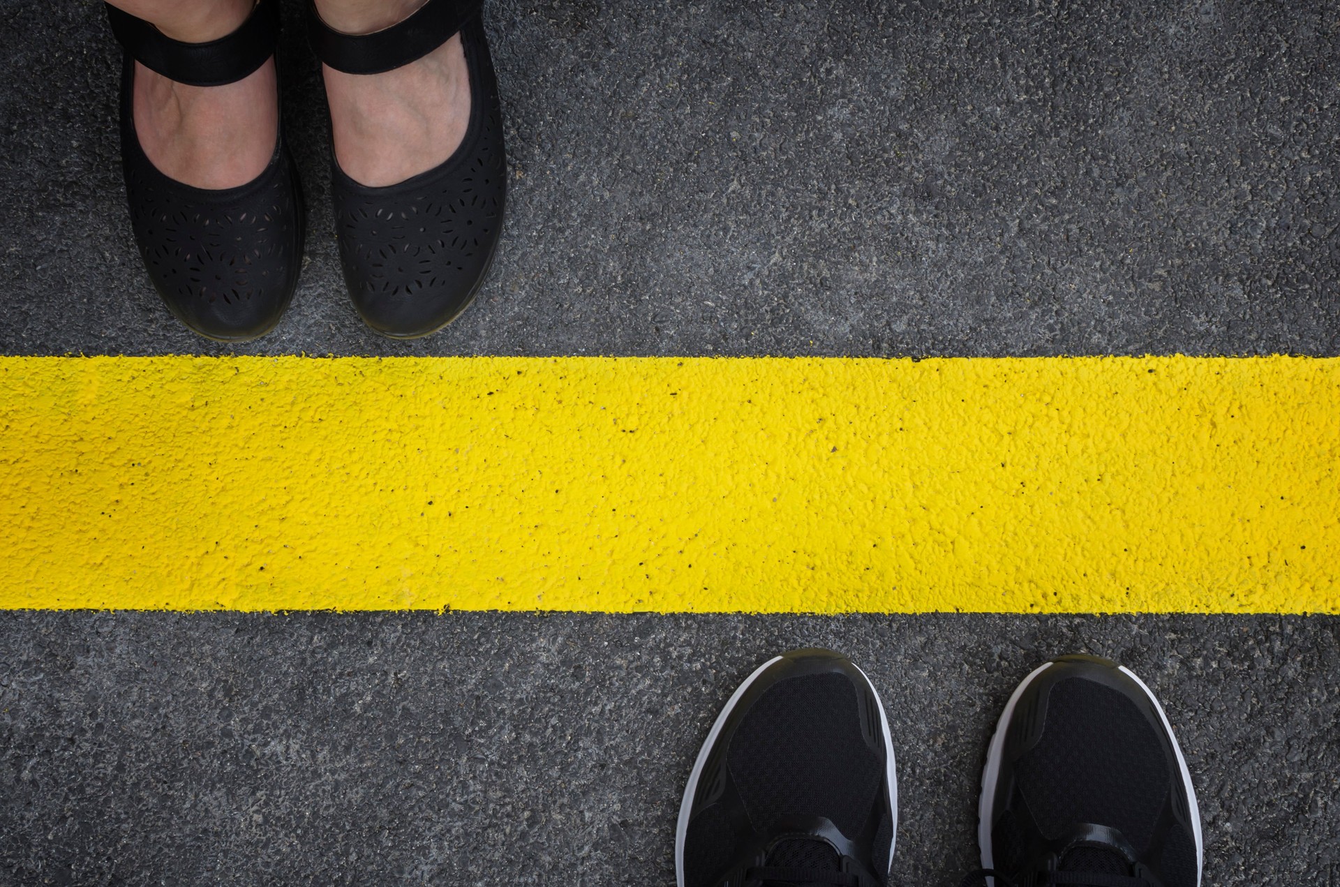 Legs of a couple standing opposite each other