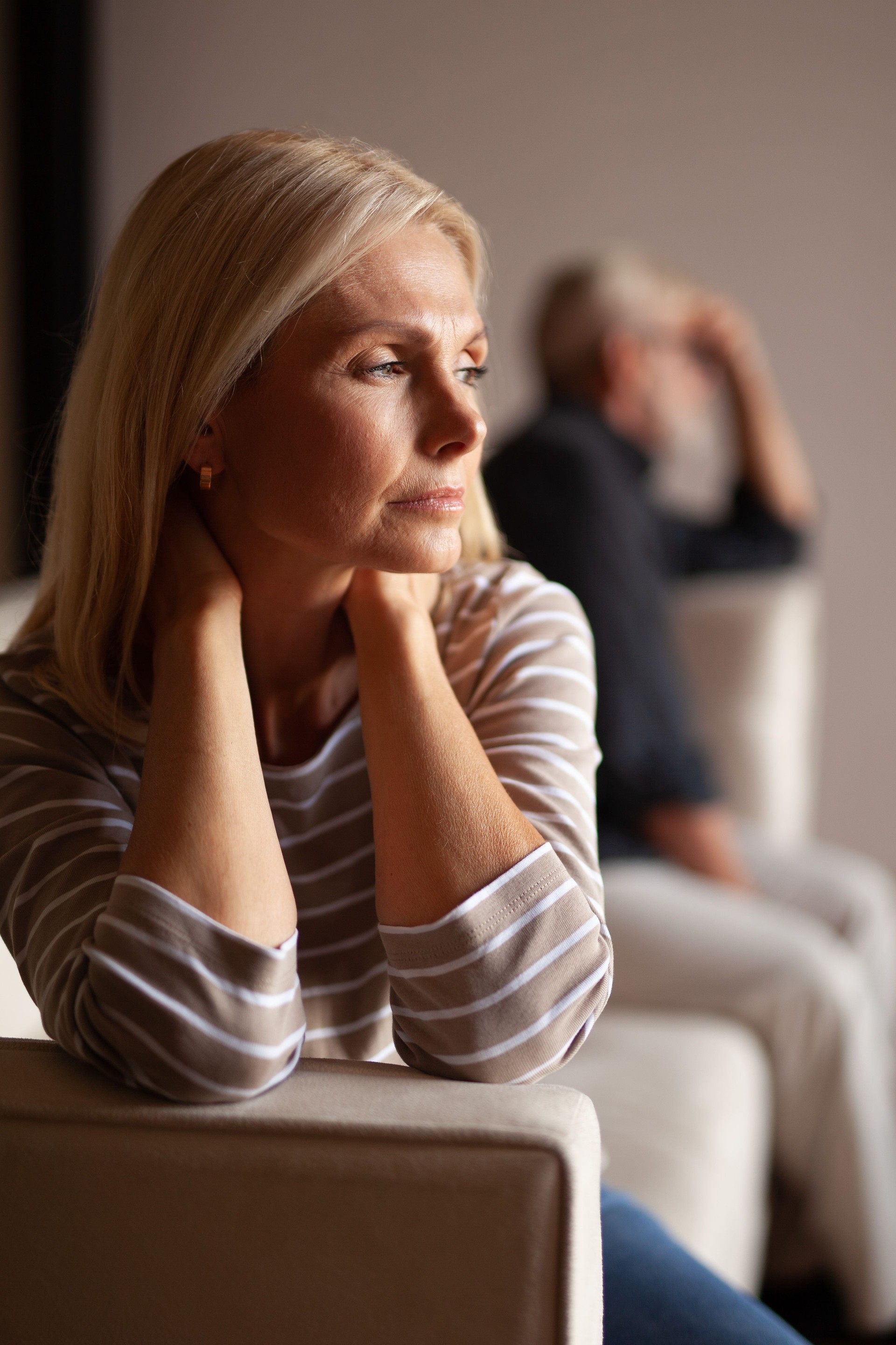 Portrait of an upset woman, a quarrel in the family. Victim of domestic violence, relationship difficulties. Husband and wife in crisis, divorce.